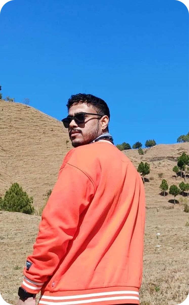 Shouvik outdoors in a red jacket